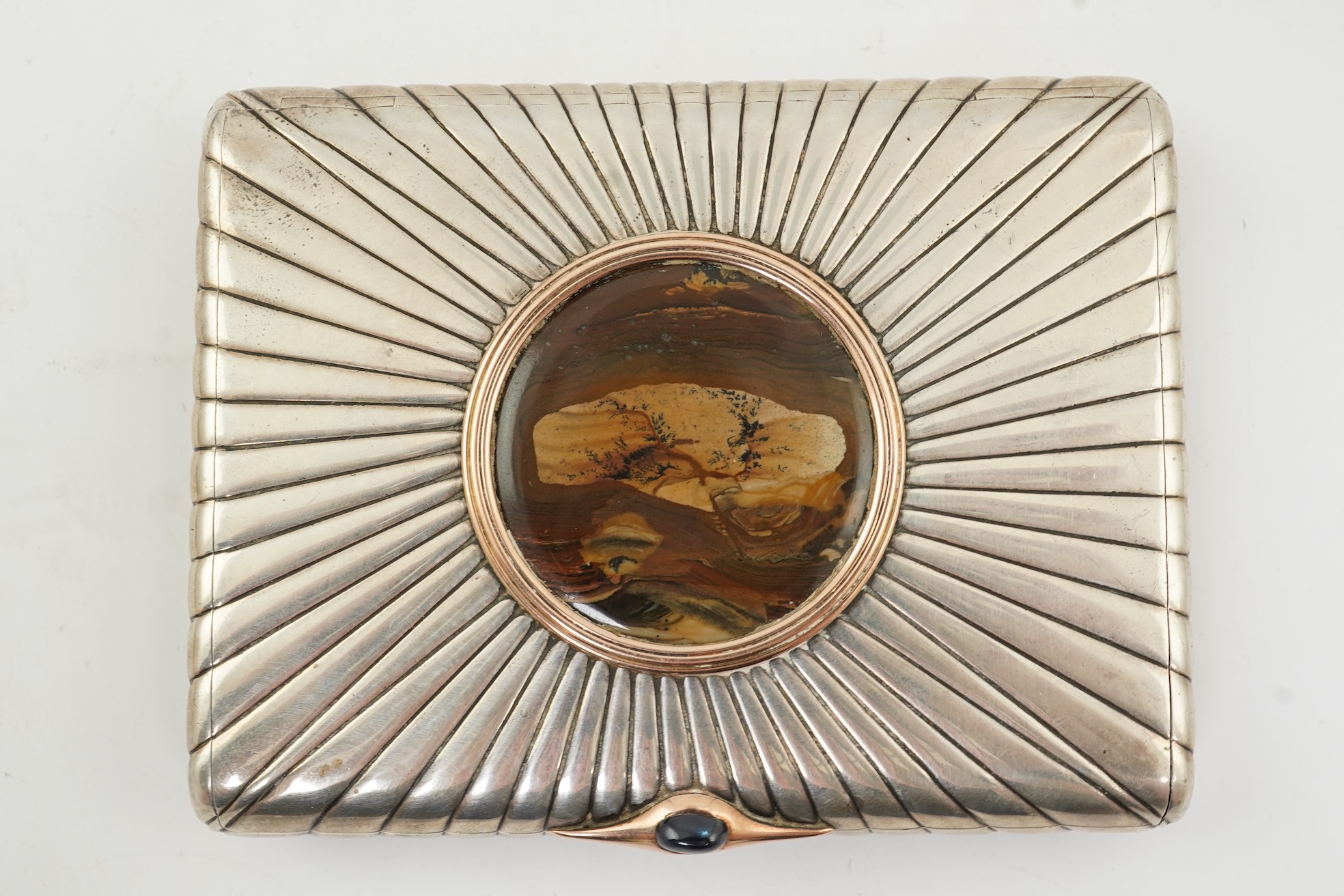 An early 20th century Russian 84 zolotnik silver cigarette case, with cappuccino agate inset cover, of ribbed rectangular form